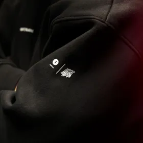 Raw2Rare Hoodie First Edition – Detailaufnahme des Light & Shadow Ärmelprints auf schwarzem Hoodie unter rotem Licht